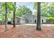Landscaped backyard featuring a spacious patio, mature trees, and a well-maintained lawn at 3708 Sweetgrass Ln, Charlotte, NC 28226