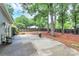 Private concrete patio with barbecue grill in a fenced backyard with mature trees for shade and privacy at 3708 Sweetgrass Ln, Charlotte, NC 28226