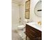 Modern bathroom with a tile floor, shower and tub combination and wooden vanity with bronze hardware at 3708 Sweetgrass Ln, Charlotte, NC 28226