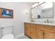 Bathroom featuring a double vanity with stylish fixtures and a framed art print at 3708 Sweetgrass Ln, Charlotte, NC 28226