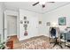 Comfortable bedroom space showing a desk, gallery wall, and hardwood flooring at 3708 Sweetgrass Ln, Charlotte, NC 28226