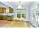 Bright breakfast nook features large windows, a modern light fixture and sleek wood laminate flooring at 3708 Sweetgrass Ln, Charlotte, NC 28226