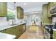 Sunlit kitchen featuring stainless steel appliances, olive cabinets, and dining area with French doors at 3708 Sweetgrass Ln, Charlotte, NC 28226