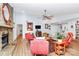 Spacious living room with a stone fireplace, ceiling fan and bright furniture at 3708 Sweetgrass Ln, Charlotte, NC 28226