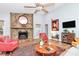 Cozy living room with stone fireplace, hearth, mantel, and a ceiling fan overhead at 3708 Sweetgrass Ln, Charlotte, NC 28226