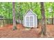 Outdoor storage shed with double doors nestled among trees, offering practical backyard storage at 3708 Sweetgrass Ln, Charlotte, NC 28226
