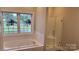 Bathroom featuring a tub, a glass enclosed shower, and natural light at 3712 Travertine Dr, Lancaster, SC 29720