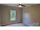 Bright bedroom with a ceiling fan and a large window overlooking the yard at 3712 Travertine Dr, Lancaster, SC 29720