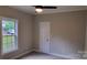 This cozy bedroom has a ceiling fan and a large window at 3712 Travertine Dr, Lancaster, SC 29720
