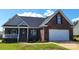 Charming brick home with a two-car garage and well-maintained landscaping in a suburban neighborhood at 3712 Travertine Dr, Lancaster, SC 29720