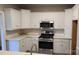 Well-equipped kitchen featuring stainless steel appliances, white cabinets, and tiled backsplash at 3712 Travertine Dr, Lancaster, SC 29720