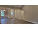 Living room with a view to front door, neutral walls, and hardwood floors at 3712 Travertine Dr, Lancaster, SC 29720