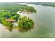 Aerial view of waterfront property at 3911 Sandy Point Rd, showing lush trees, a private dock and peaceful setting at 3911 Sandy Point Dr, York, SC 29745
