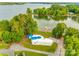 Aerial view of a lakeside home featuring mature trees, a private dock, and stunning waterfront views at 3911 Sandy Point Dr, York, SC 29745