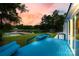 Scenic backyard with a wooden deck, waterfront views, lush green lawn, and tranquil lake access at 3911 Sandy Point Dr, York, SC 29745