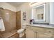 Well-lit bathroom with stone shower, granite countertop vanity and illuminated mirror for a modern feel at 3911 Sandy Point Dr, York, SC 29745