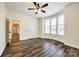 Inviting bedroom with hardwood floors and bay windows, showcasing a chandelier in the arched doorway at 3911 Sandy Point Dr, York, SC 29745
