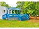 Exterior view of home featuring a tiered blue deck, lattice work, and a private backyard at 3911 Sandy Point Dr, York, SC 29745