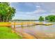 Scenic lake view featuring a private wooden dock that is perfect for boating and waterfront activities at 3911 Sandy Point Dr, York, SC 29745