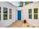 Bright blue front door framed by white walls and manicured landscape at 3911 Sandy Point Dr, York, SC 29745