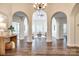 Bright living room featuring arched doorways, hardwood floors, and a modern chandelier at 3911 Sandy Point Dr, York, SC 29745