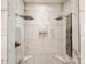 Stunning tiled walk-in shower featuring dual shower heads and built-in niche for a spa-like experience at 3911 Sandy Point Dr, York, SC 29745