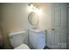 Bathroom with marble countertop vanity, toilet, mirror, and shower features a classic and functional design at 4037 Lakota Ct, Charlotte, NC 28269