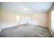 Spacious bedroom with carpet, high ceilings, natural light, and a view of the ensuite bathroom at 4037 Lakota Ct, Charlotte, NC 28269
