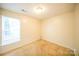 Bedroom features light walls, carpeted floors, natural light, and is perfect for creating a personal haven at 4037 Lakota Ct, Charlotte, NC 28269