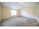 Carpeted bedroom with window, light fixture, and neutral-colored walls, offering a cozy atmosphere at 4037 Lakota Ct, Charlotte, NC 28269