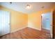 Bright bedroom featuring laminate flooring, white door, and tan painted walls at 4037 Lakota Ct, Charlotte, NC 28269