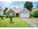 Charming brick home with an attached garage, well-manicured lawn, and inviting landscaping at 4037 Lakota Ct, Charlotte, NC 28269