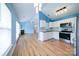 Modern kitchen with stainless steel appliances, white cabinets, and hardwood flooring open to the living room at 4037 Lakota Ct, Charlotte, NC 28269