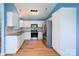Modern kitchen features stainless steel appliances, white cabinets, and hardwood flooring at 4037 Lakota Ct, Charlotte, NC 28269
