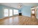 Bright living room with hardwood floors, fireplace, ceiling fan, and sliding glass doors to the outside at 4037 Lakota Ct, Charlotte, NC 28269