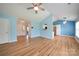 Open concept living room featuring hardwood floors, ceiling fan, and view into entry and kitchen at 4037 Lakota Ct, Charlotte, NC 28269