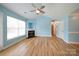 Well-lit living room with a fireplace, hardwood floors, and view of front yard from the window at 4037 Lakota Ct, Charlotte, NC 28269