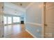 Bright living room with hardwood floors, fireplace, ceiling fan, and access to the backyard through glass doors at 4037 Lakota Ct, Charlotte, NC 28269