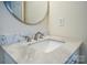 Close-up of bathroom vanity with marble countertop and modern faucet at 4037 Lakota Ct, Charlotte, NC 28269