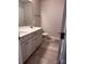 Bathroom featuring double sinks, gray cabinets, and light tile floors at 4041 Port Richmond Ave # 9, Gastonia, NC 28056