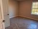 This bedroom has neutral walls, carpet covered in plastic, and a window with a wooded view at 4041 Port Richmond Ave # 9, Gastonia, NC 28056