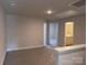 Bonus room has neutral walls and carpet covered in plastic, with a view to an adjacent bathroom at 4041 Port Richmond Ave # 9, Gastonia, NC 28056