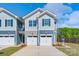 Up close view of townhome exterior shows stylish facade, double garage, and attractive landscaping at 4041 Port Richmond Ave # 9, Gastonia, NC 28056
