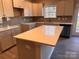 Bright kitchen features white cabinets, a gray backsplash, stainless steel appliances, and a large island at 4041 Port Richmond Ave # 9, Gastonia, NC 28056