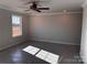Main bedroom featuring neutral walls, a ceiling fan, and a large window with a wooded view at 4041 Port Richmond Ave # 9, Gastonia, NC 28056