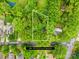 Aerial view of a wooded lot outlined in white with mature trees and established landscaping at 4114 Stacy Blvd, Charlotte, NC 28209