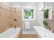 Bathroom with tiled shower-tub combination, vanity and a window at 4114 Stacy Blvd, Charlotte, NC 28209