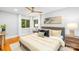 Light filled bedroom featuring hardwood floors, neutral colors, two windows and ceiling fan at 4114 Stacy Blvd, Charlotte, NC 28209