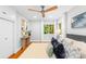 Light filled bedroom featuring hardwood floors, neutral colors, two windows and ceiling fan at 4114 Stacy Blvd, Charlotte, NC 28209
