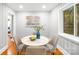 Bright dining area featuring a round table, art and picture window offering natural light at 4114 Stacy Blvd, Charlotte, NC 28209